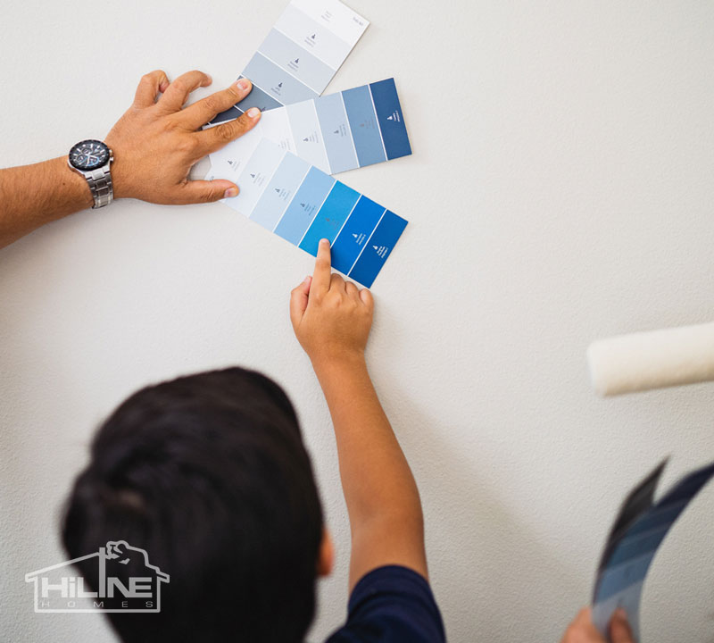 Image of family looking at paint samples on the wall.